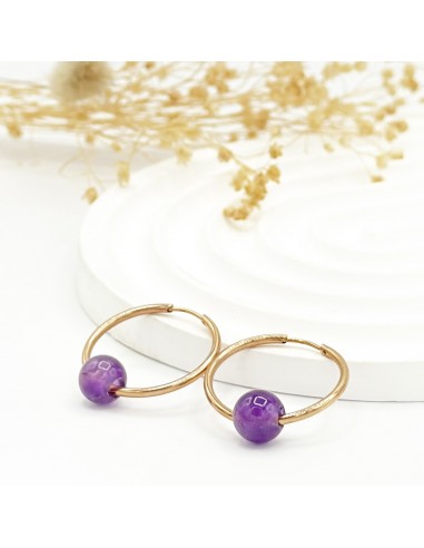 Argollas de amatista en acero para tranquilidad emocional, protección energética y claridad mental.