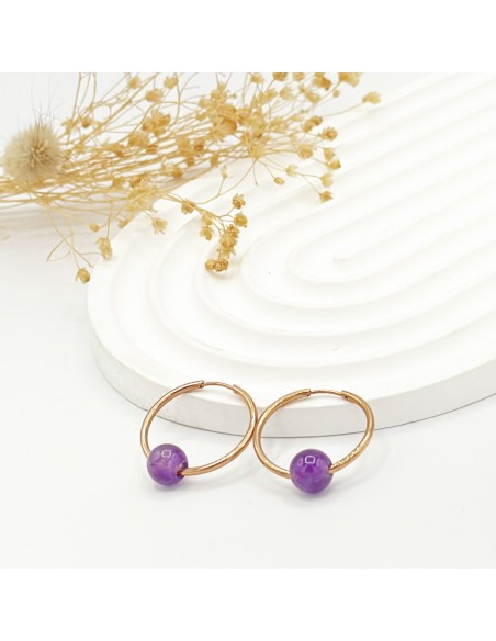 Argollas de amatista en acero para tranquilidad emocional, protección energética y claridad mental.